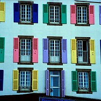 Haus mit verschiedenfarbigen Fensterläden